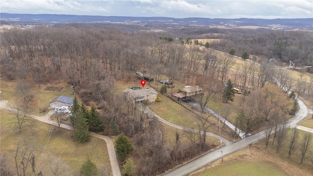 drone / aerial view featuring a wooded view