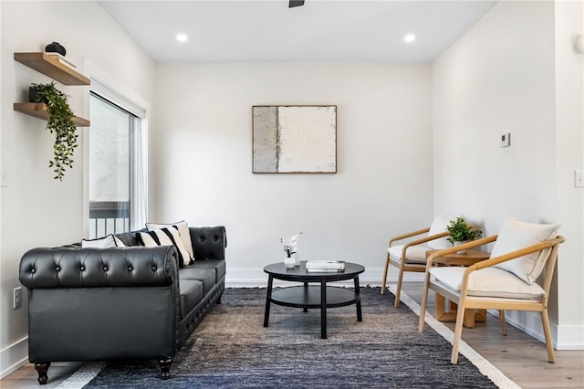 living area with recessed lighting, baseboards, and wood finished floors