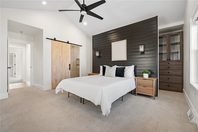 bedroom featuring light carpet, a barn door, baseboards, vaulted ceiling, and recessed lighting