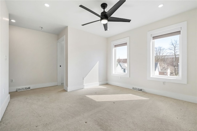 spare room with carpet, visible vents, baseboards, and recessed lighting