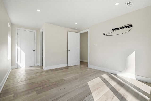 unfurnished bedroom featuring light wood finished floors, visible vents, and recessed lighting