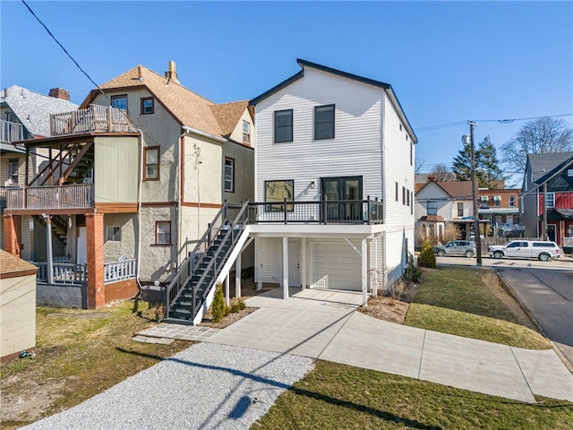 view of front of home featuring stairs, driveway, and a garage