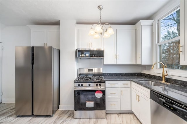 kitchen featuring appliances with stainless steel finishes, a sink, and white cabinetry