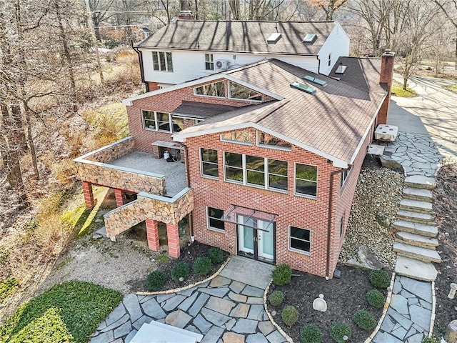 exterior space featuring stairway and brick siding