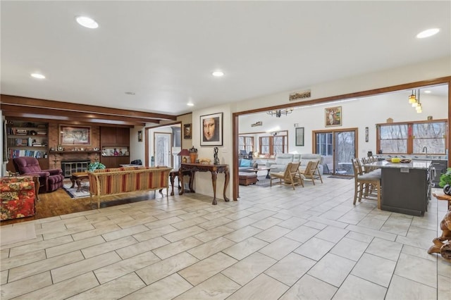 living room featuring a glass covered fireplace, light tile patterned floors, and recessed lighting