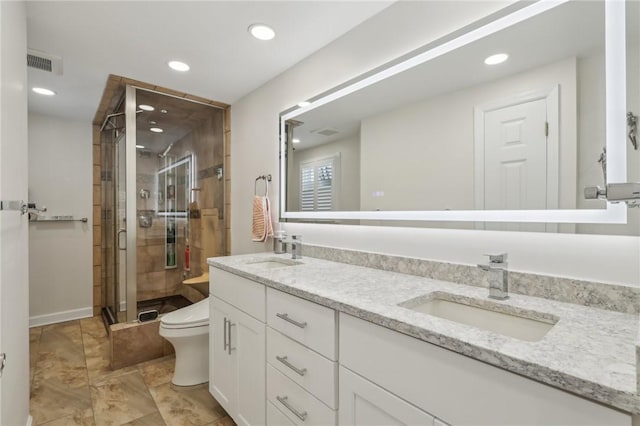 full bathroom featuring a stall shower, visible vents, a sink, and toilet