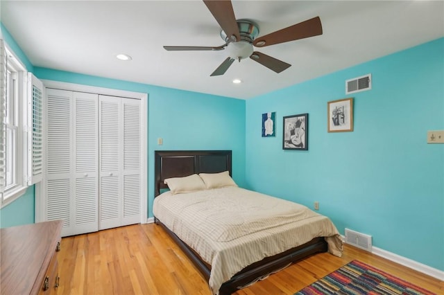 bedroom featuring a closet, visible vents, and wood finished floors