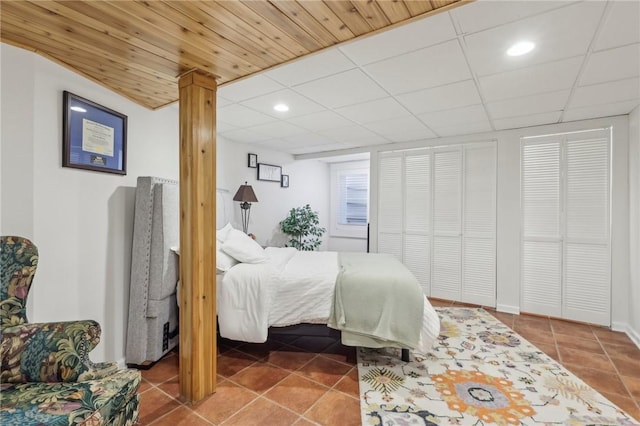 bedroom featuring a paneled ceiling, recessed lighting, and tile patterned floors