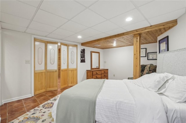 bedroom with recessed lighting, a drop ceiling, and tile patterned floors