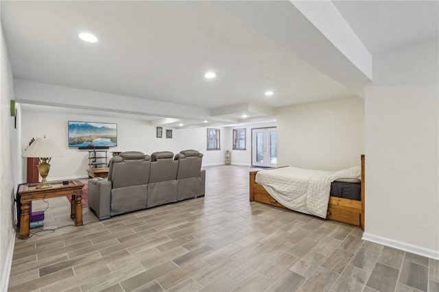 bedroom featuring baseboards, wood finish floors, and recessed lighting