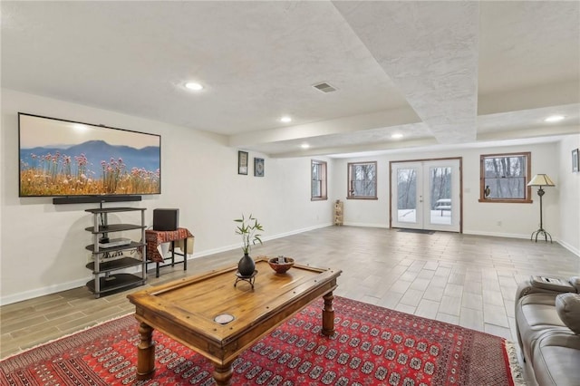 living area featuring visible vents, baseboards, wood tiled floor, french doors, and recessed lighting