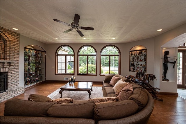 living room with baseboards, a ceiling fan, wood-type flooring, a fireplace, and recessed lighting