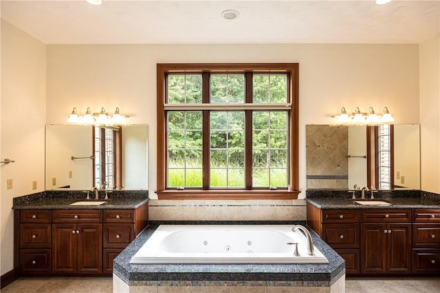 full bathroom with two vanities, plenty of natural light, and a sink