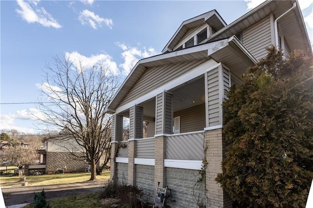 view of property exterior with a porch