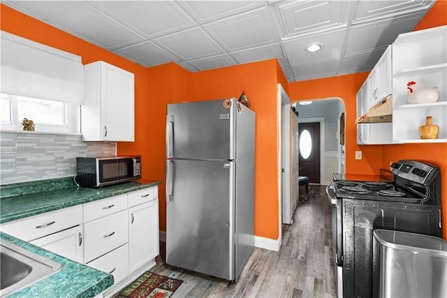 kitchen with under cabinet range hood, stainless steel appliances, light wood-style floors, white cabinets, and open shelves