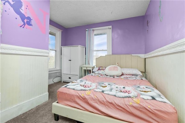 carpeted bedroom with a textured ceiling