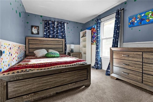 bedroom featuring a wainscoted wall and carpet floors