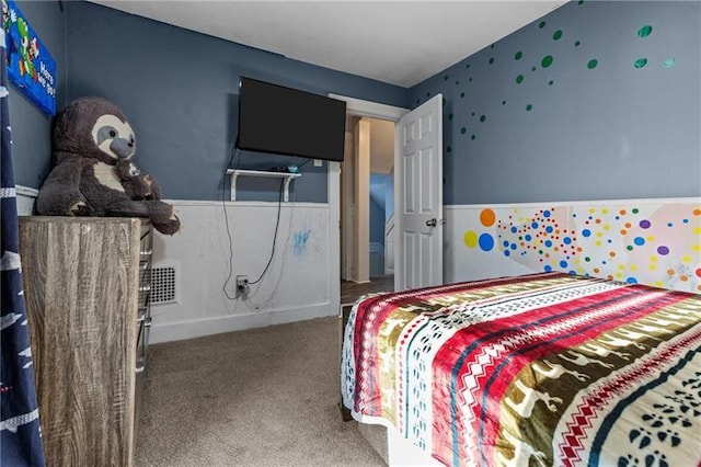 bedroom featuring carpet and wainscoting