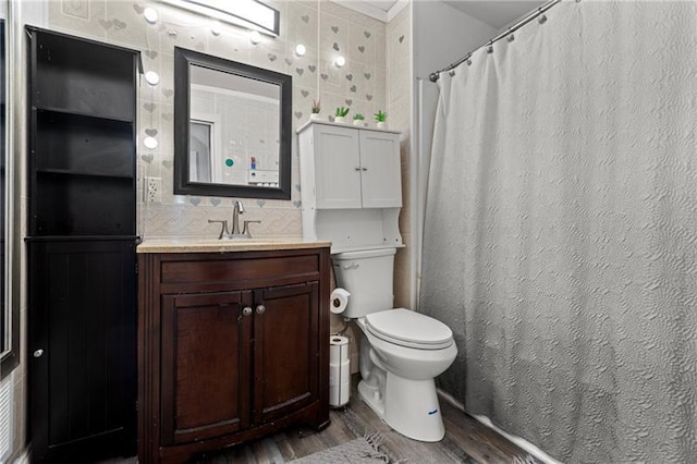 bathroom with curtained shower, backsplash, toilet, vanity, and wood finished floors