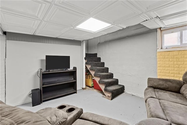 living room featuring concrete floors and stairs