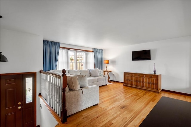 living area featuring light wood-type flooring and baseboards