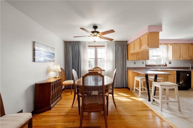 dining space featuring ceiling fan and light wood-style floors