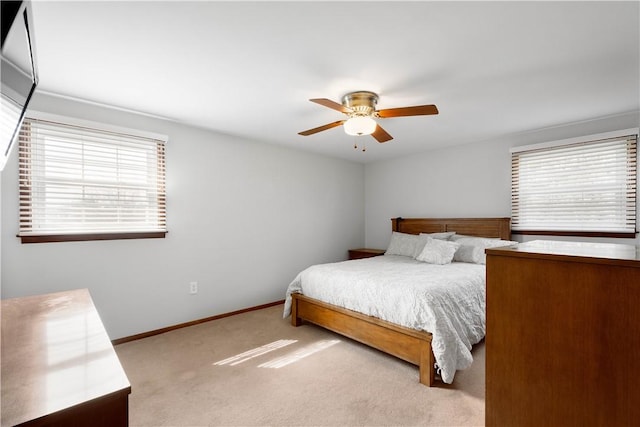 bedroom with carpet, baseboards, and a ceiling fan