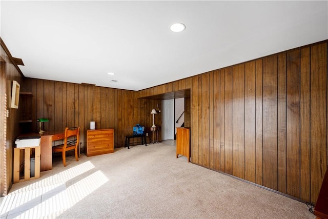 unfurnished office with wooden walls, recessed lighting, and light colored carpet