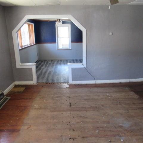 bonus room featuring baseboards and wood finished floors