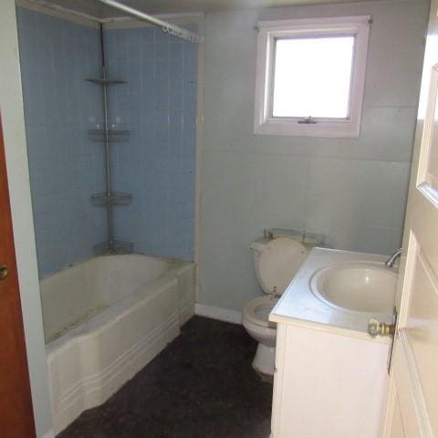 bathroom with tub / shower combination, vanity, toilet, and baseboards