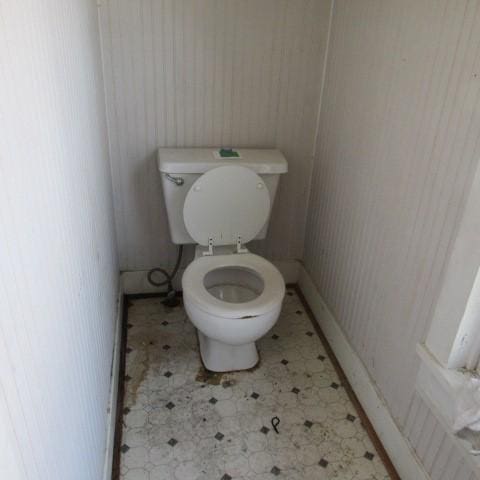 bathroom with toilet and tile patterned floors