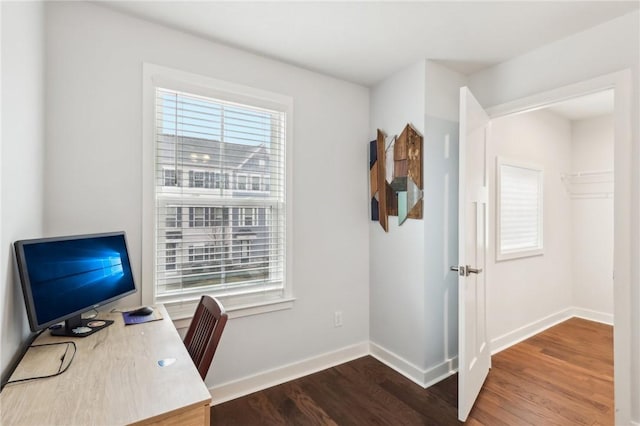 office space featuring dark wood-type flooring and baseboards