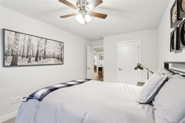 bedroom with a ceiling fan and baseboards