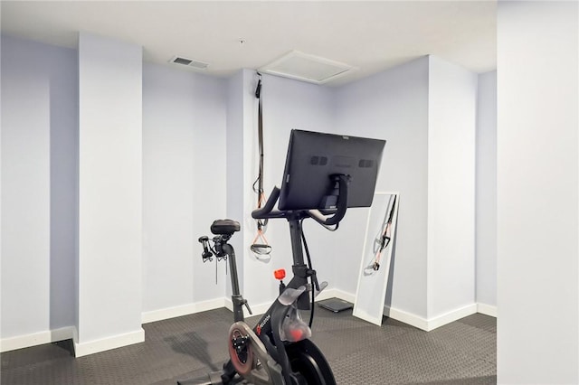 exercise area featuring baseboards and visible vents