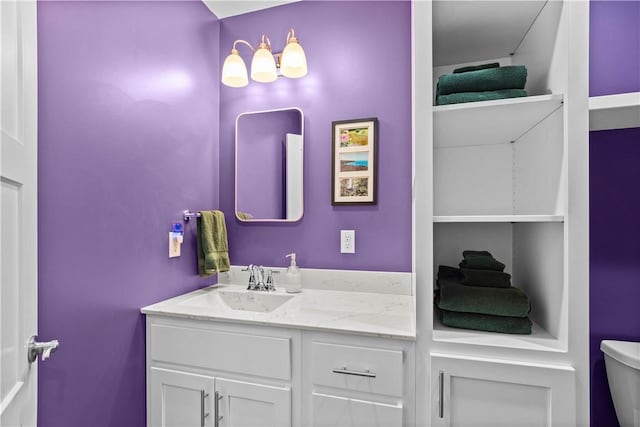 bathroom featuring toilet and vanity