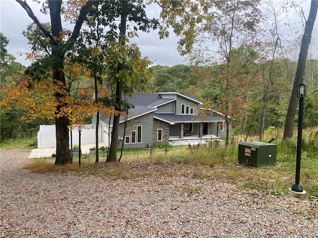 view of side of home with a forest view