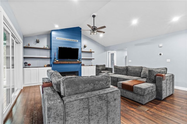 living area featuring ceiling fan, dark wood-type flooring, a fireplace, baseboards, and vaulted ceiling