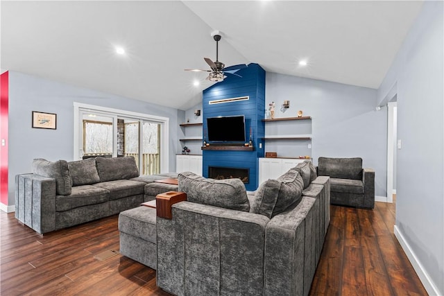 living room featuring dark wood-style floors, ceiling fan, a fireplace, and vaulted ceiling