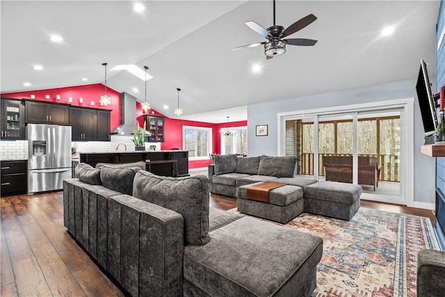 living area with dark wood-type flooring, recessed lighting, vaulted ceiling, and a ceiling fan