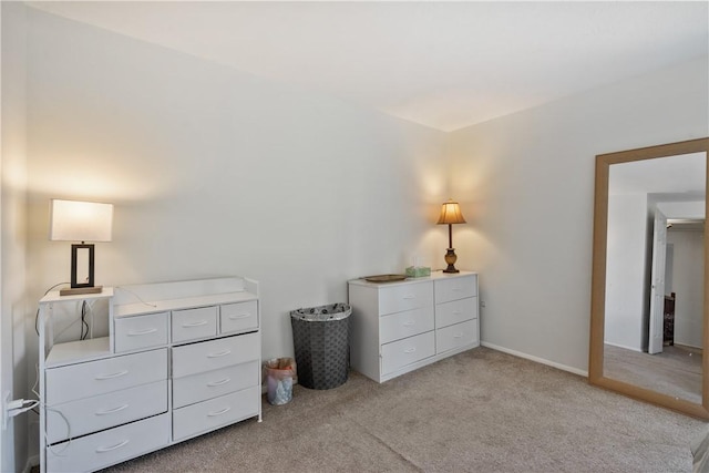 bedroom featuring baseboards and light colored carpet