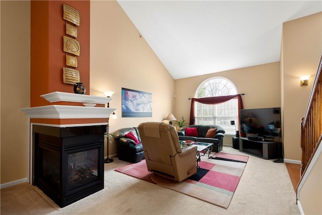 carpeted living room featuring high vaulted ceiling, stairway, a multi sided fireplace, and baseboards