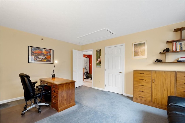home office featuring attic access, dark colored carpet, and baseboards