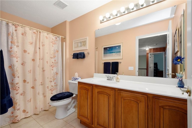 bathroom featuring tile patterned flooring, visible vents, toilet, vanity, and a shower with shower curtain