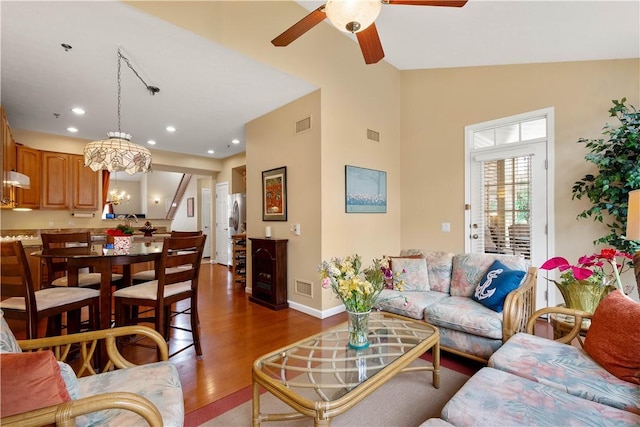 living room with visible vents, baseboards, recessed lighting, wood finished floors, and ceiling fan