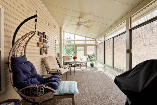 sunroom with vaulted ceiling and a ceiling fan