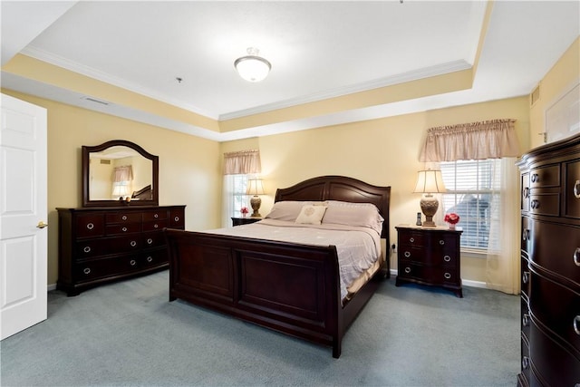 bedroom with ornamental molding, a raised ceiling, and light carpet