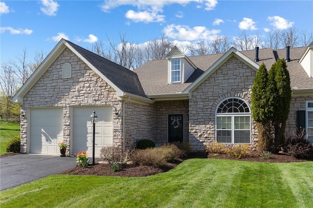 view of front facade with stone siding, roof with shingles, a front yard, and a garage