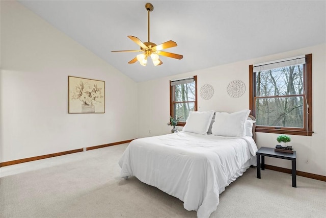 bedroom featuring lofted ceiling, ceiling fan, baseboards, and light colored carpet