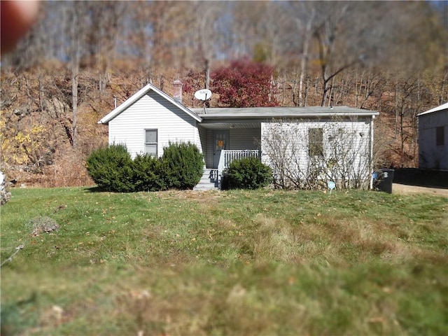 view of front of home with covered porch and a front yard