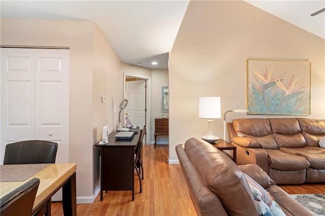 living room with light wood-type flooring, lofted ceiling, baseboards, and recessed lighting